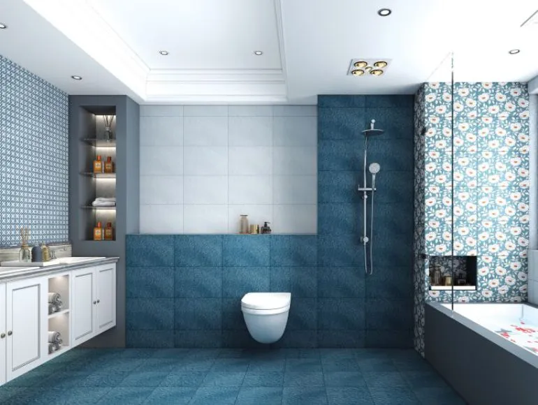 Trendy blue bathroom design with bathtub, sink and western toilet for a sleek look